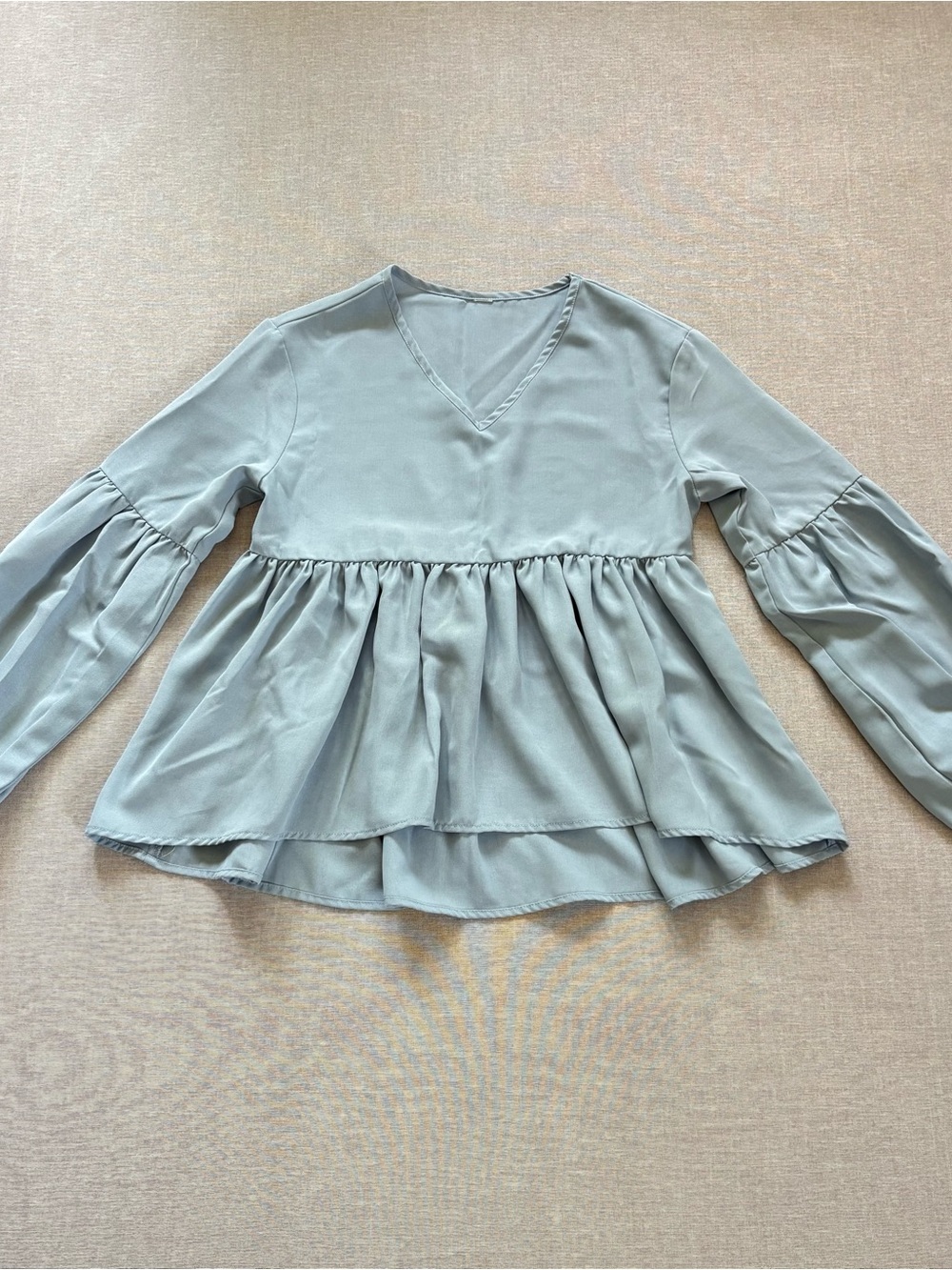 Light blue romantic boho blouse with ruffled hem and balloon sleeves